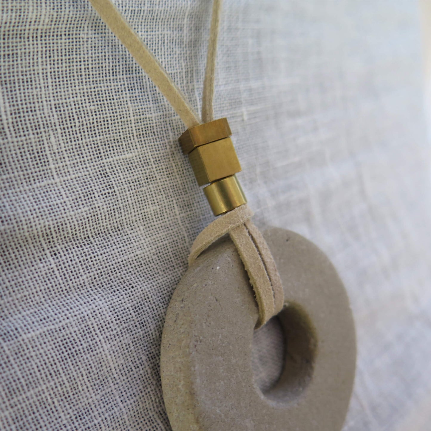 Concrete pendant on vegan suede with antique bronze and raw brass #2