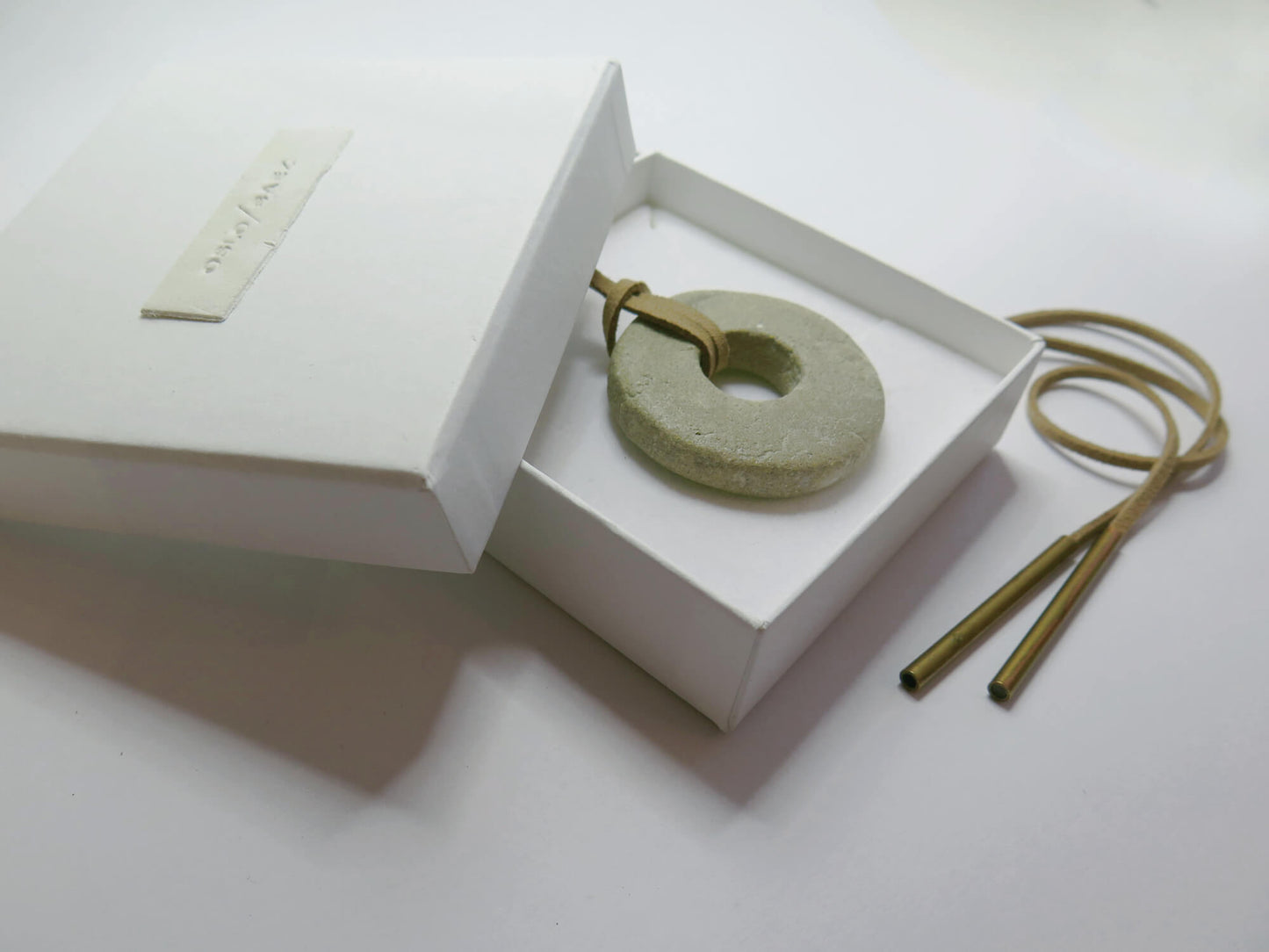 White gift box with handmade clay label